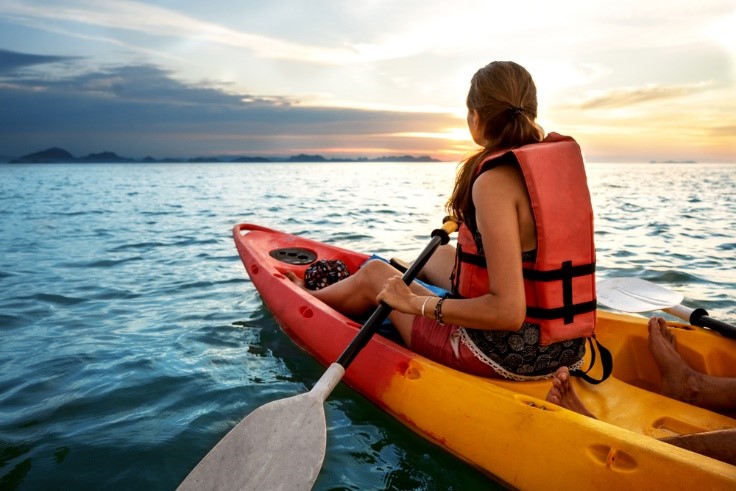 woman kayaking in the ocean