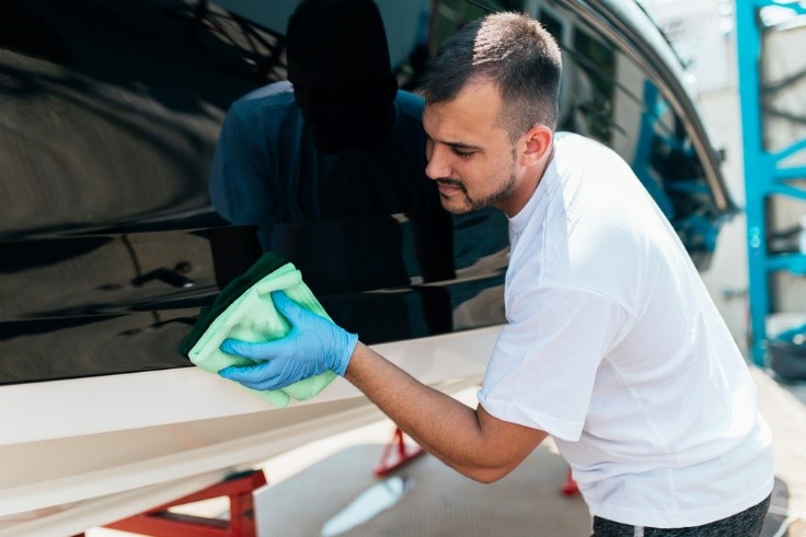 young Caucasian male cleaning a boat