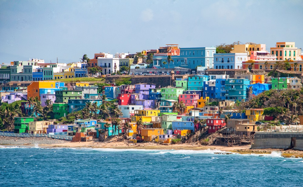 Colorful houses on a hillside next to a beach