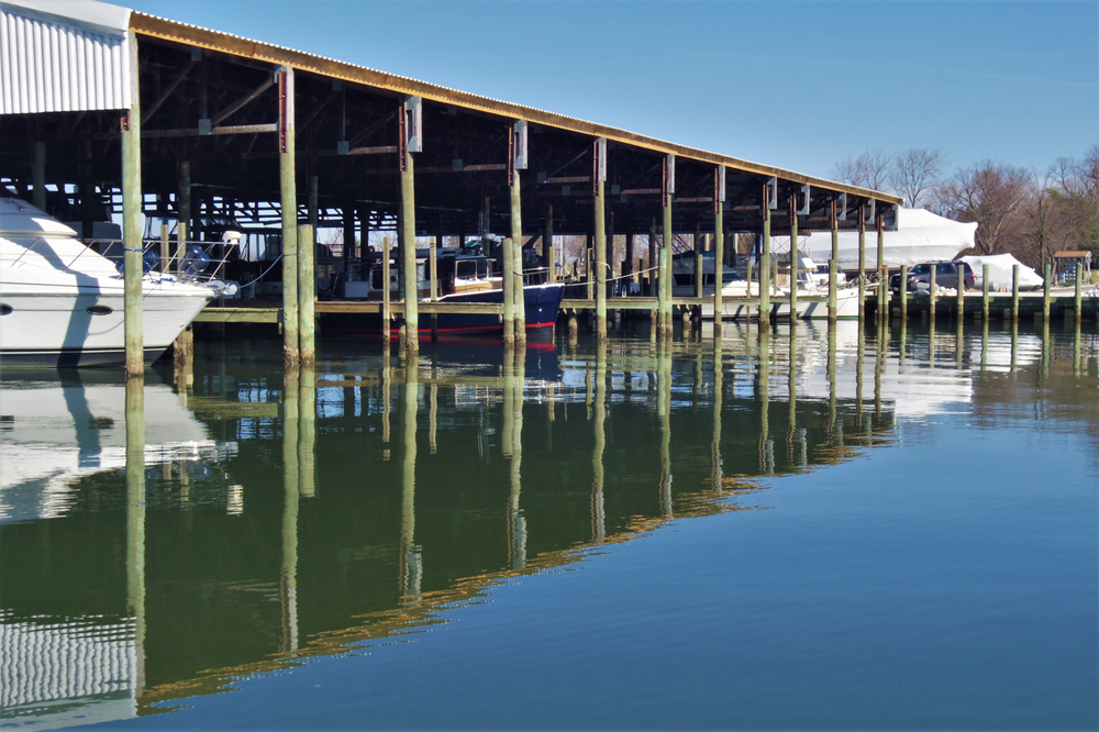 Dock with overhead covers for boat storage